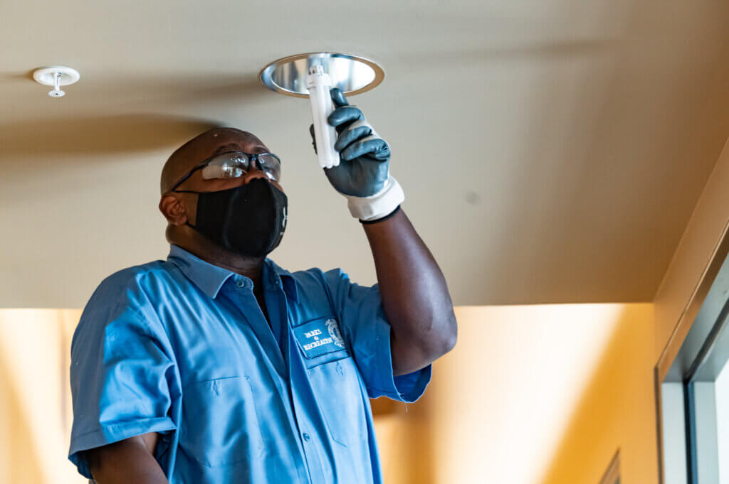 man working to install light